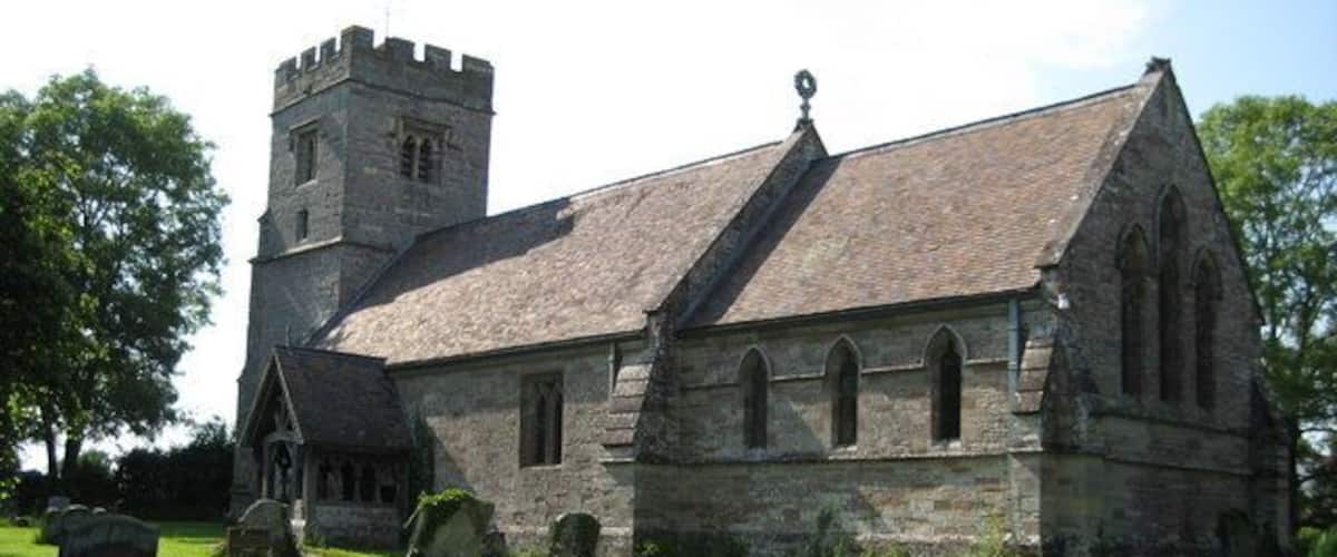 A historic church with a tower and a graveyard.