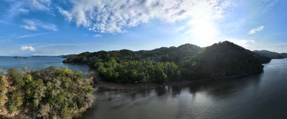 A river surrounded by dense forest and hills.