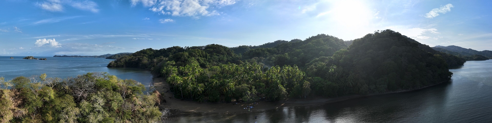 A river surrounded by dense forest and hills.