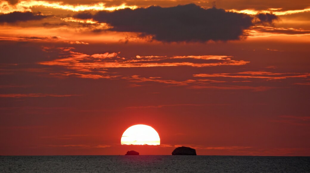 fiery sunset over the pacific ocean and catalinas islands from sugar beach resort at playa azucar cove, near playa flamingo, costa rica