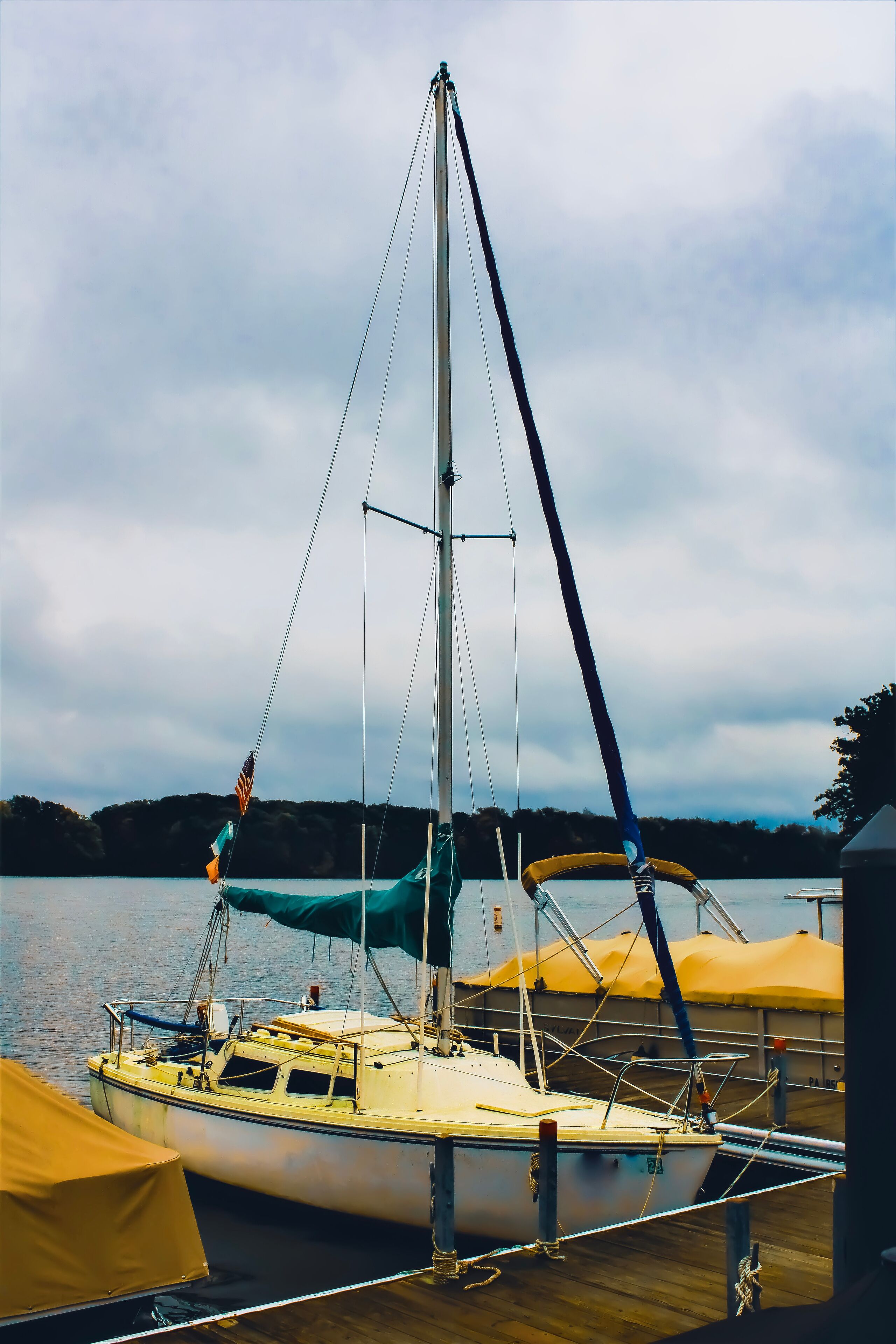 A docked sailboat in a marina on Pymatuning Lake in a park in Jamestown, Pennsylvania