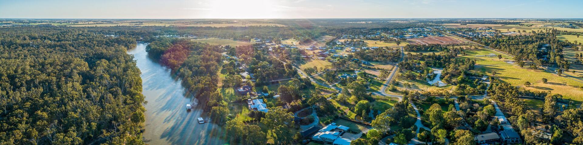 Aerial panorama of Moama town and Murray River at sunset