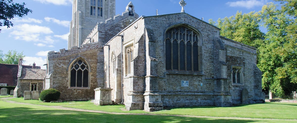 A historic church with a tall tower and arched windows.