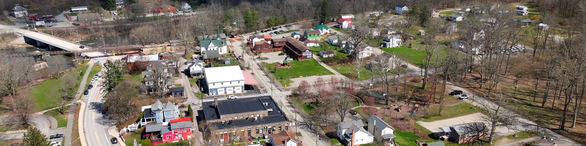 Small mountain town Ohiopyle, Pennsylvania with state park by Youghiogheny River used for whitewater rafting and kayaking adventures and near hiking trails and waterfalls