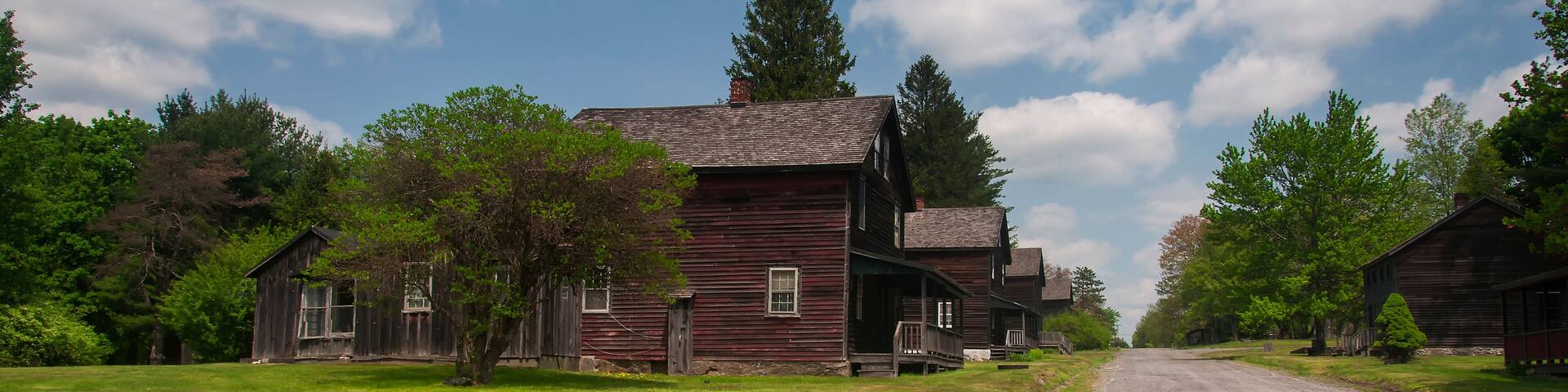 clapboard homes lining a dirt road in the historic eckley miners village in pennsylvania