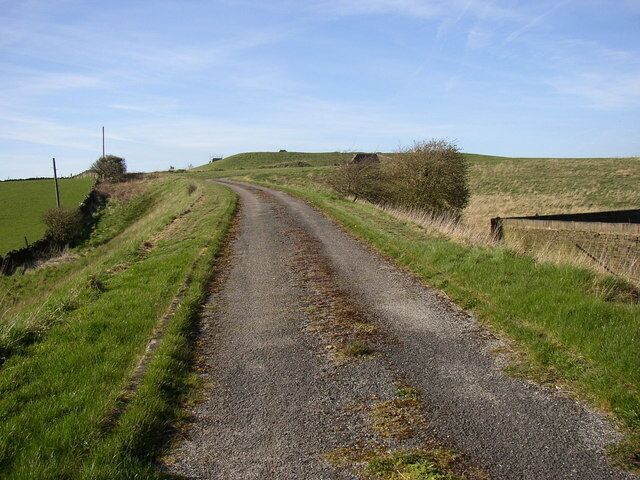 Shepley Service Reservoir, Penistone Road Service reservoirs are awkward to photograph, being on the top of hills! The water is pumped up to here, and then flows to Shepley by gravity. As it is treated water the reservoir has to be covered. This view is looking up the access drive from Penistone Road.