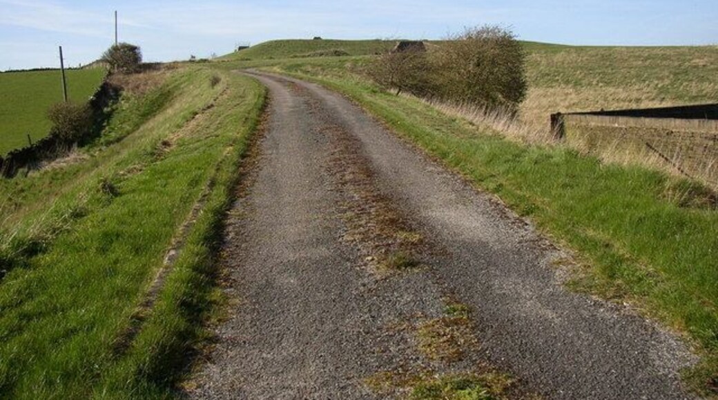 Shepley Service Reservoir, Penistone Road Service reservoirs are awkward to photograph, being on the top of hills! The water is pumped up to here, and then flows to Shepley by gravity. As it is treated water the reservoir has to be covered. This view is looking up the access drive from Penistone Road.