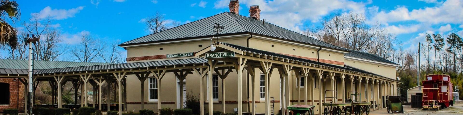 The Branchville Railroad Depot is listed on the National Register of Historic Places.
The front of the structure now houses a museum/shrine of railroad memorabilia, including a caboose. It is open by appointment and children are welcome. Informal tours are led by John Norris, a retired railroad company executive. Admission is free but donations toward the upkeep of the museum are appreciated. Call (803) 707-1788 for information.
The rear of the structure houses the Eatery at the Depot, which serves dinners on Thursday, Friday and Saturday evenings. Reservations are recommended but not required. Call (803) 274-8001 or (803) 515-
