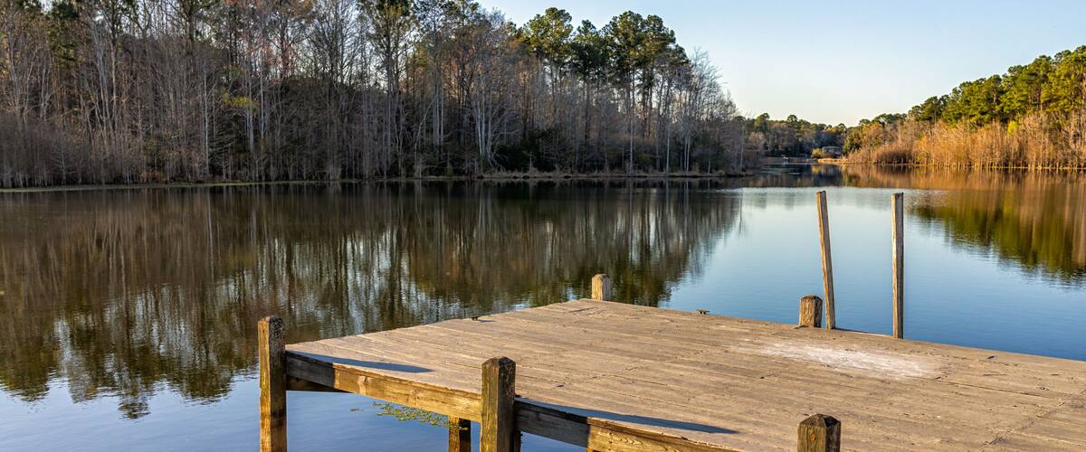 Eutawville, South Carolina sunset near Lake Marion with boat dock and water landscape view at Fountain lake in spring evening with nobody