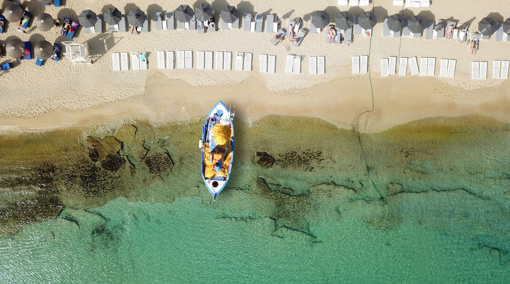 Aerial photo from traditional picturesque fishing boat on turquoise clear sea as seen from top in island of Paros, Cyclades, Greece