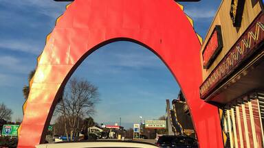 A sign with 'South of the Border' written on it, with a large sombrero and face above.