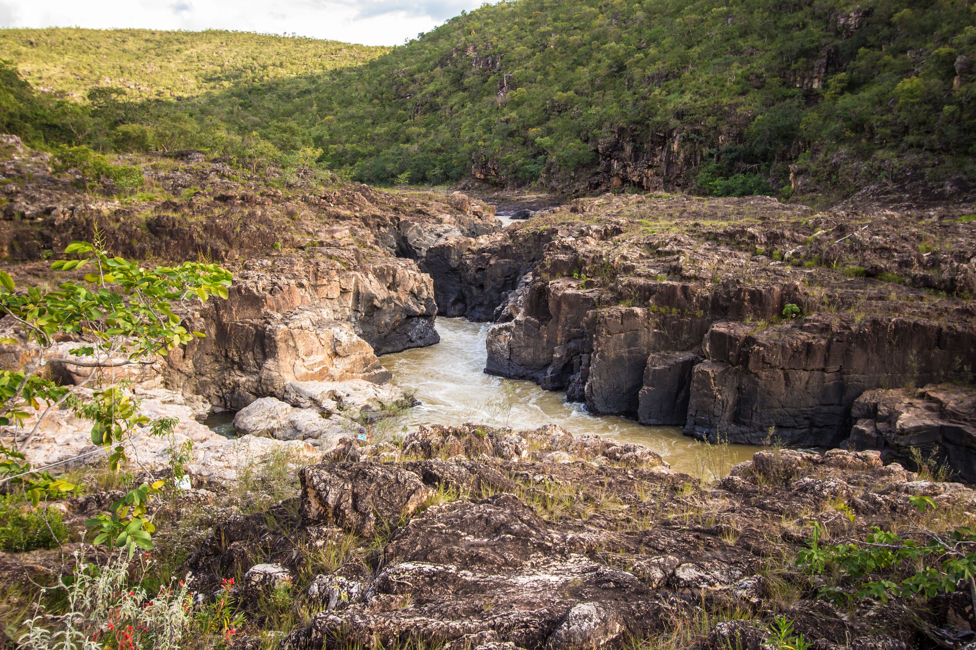A rocky canyon with a flowing river.