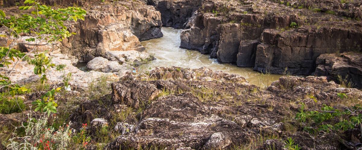 A rocky canyon with a flowing river.