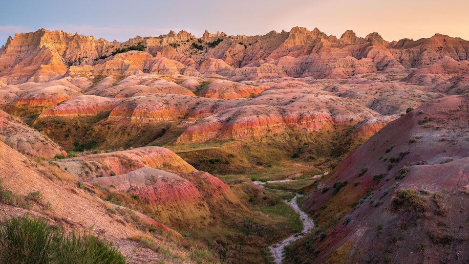 A rugged landscape with rolling hills and a river.