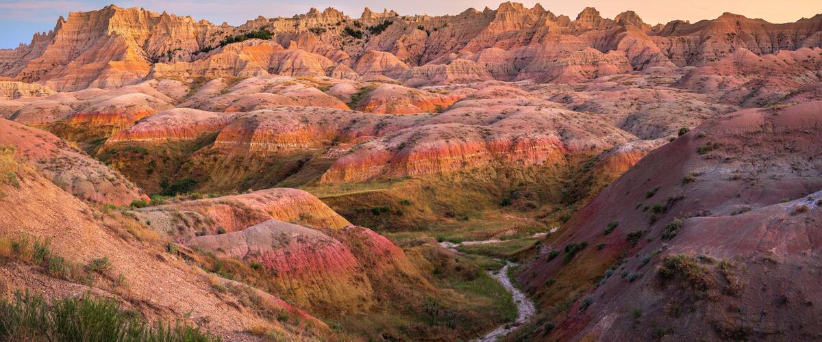 A rugged landscape with rolling hills and a river.