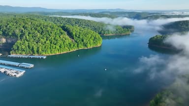 Landscape with lake beneath morning clouds and fog in mountains of Tennessee near Rocky Top at Norris Dam