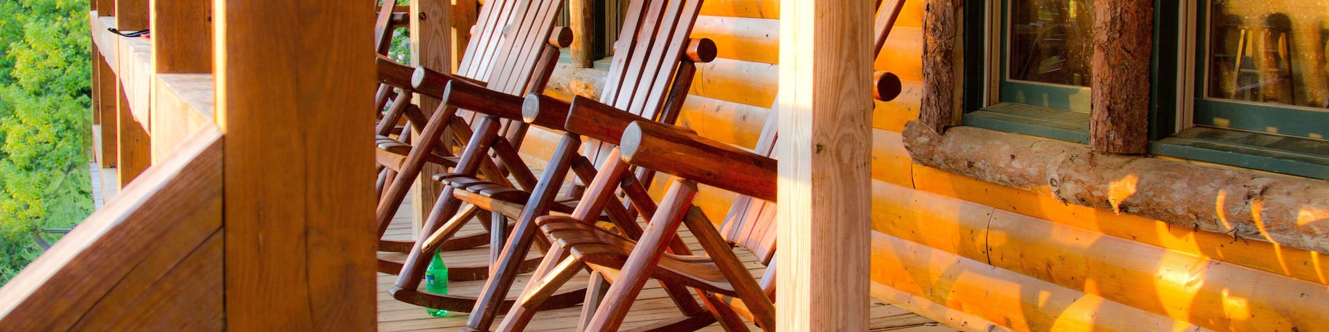 Wooden cabin with rocking chairs on wrap around porch in Copperhill, Tennessee, USA.