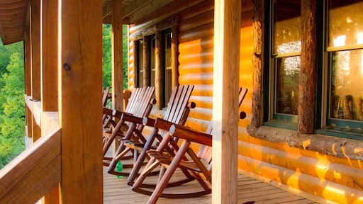 Wooden cabin with rocking chairs on wrap around porch in Copperhill, Tennessee, USA.