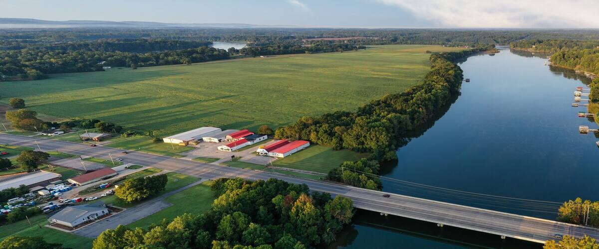 Panorama of a bridge crossing the Elk River. Aerial, overhead, view, of lakefront homes and floating boat docks on Tims Ford Lake in Estill Springs,Tennessee.