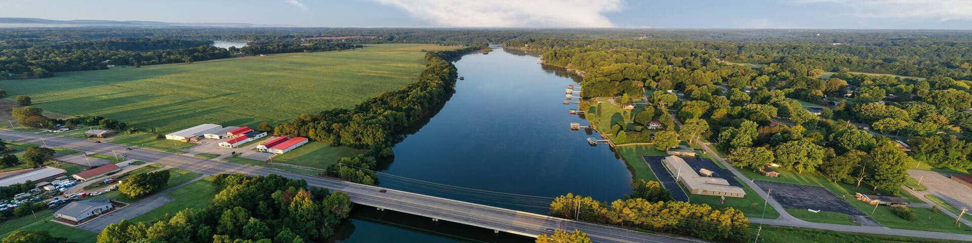 Panorama of a bridge crossing the Elk River. Aerial, overhead, view, of lakefront homes and floating boat docks on Tims Ford Lake in Estill Springs,Tennessee.