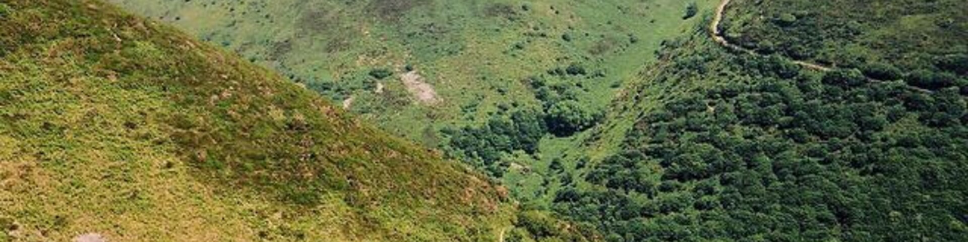 Trentishoe: overlooking Heddon's Mouth Cleave. The South West Coast Path is just visible on both sides of the valley. The higher path on the hills opposite leads to Woody Bay