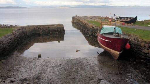 Corrie Harbour, Isle of Arran On a short stretch of Arran coastline of less than three kilometres, there are no less than three man-made harbours or jetties, as well as a fourth natural harbour. From the north, they are: Sannox Jetty, Corrie Harbour (otherwise known as 'The Port'), Ferry Rock (the natural harbour) and the Sandstone Jetty. This tiny harbour is 'The Port', which dries at low water. Due to its very narrow entrance, only small leisure craft can enter the enclosed harbour.