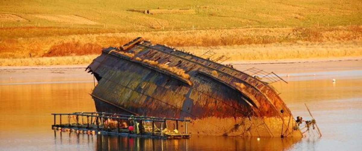 Blockship - Number 3 barrier They don't all look the same you know. They even have their own names. This one is called Reginald and he's about 100 years old, (and still earning his keep as a creel rack). The early morning winter sun brought out the colours.