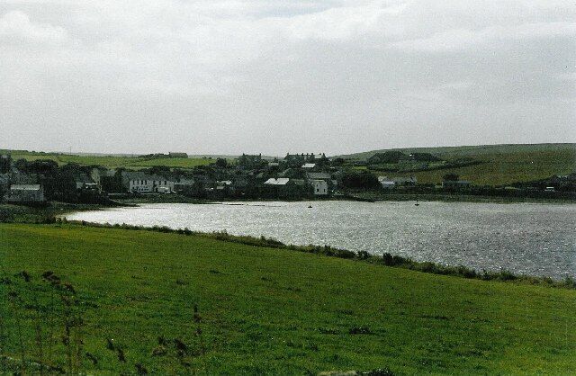 St Margaret's Hope. The pretty bay and village, seen from the hillside by the A961, looking southwest.