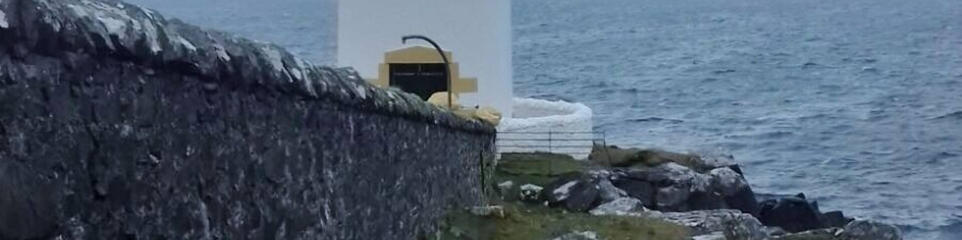 Between Port Charlotte and Bruichladich, on the Isle of Islay stand little Loch Indaal Lighthouse.
Very cloudy and raining on this particular day.
Light Established: 1869
Engineer: David & Thomas Stevenson
Character: flash every 7 s, white or red depending on direction.
Range: White 24 miles, Red 21 miles
Tower height: 13 metres.