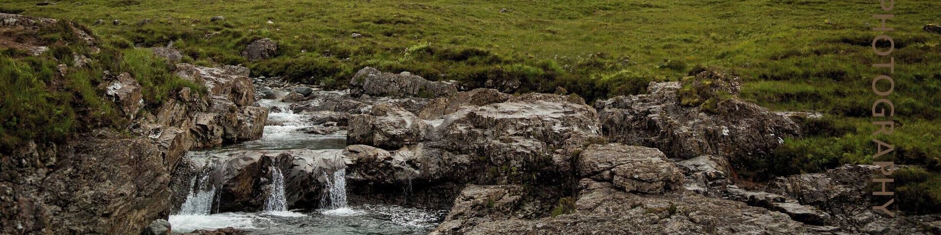 The Fairy Pools near Glenbrittle at the foot of the Black Cuillin Mountains on the Isle of Skye in the Highlands of Scotland. Very busy attraction but oh so beautiful to see.....walk along the path beside the falls and meandering river and enjoy this stunning location. Free admission is a bonus but watch the slippery rocks and steep climb back to the car, it's a bit of a killer! Perhaps partake in a coffee from Cuillin Coffee Van in the carpark when you're done.
