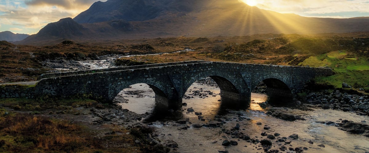 The Isle of Skye has always been seen as a magical place. Along with the beautiful landscape there are plenty of myths and legends to stimulate your imagination. With the landscape it’s easy to believe these stories. The Sligachan Bridge has a great tale, and what’s more you can gain eternal beauty from the waters below the bridge.
This photo was photographed from the new bridge with a view of the Cuillins Mountains at the back.