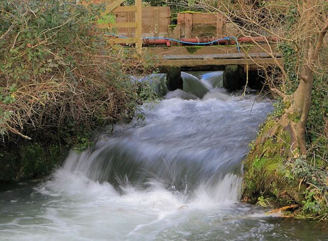 Sluice upstream of the weir at Upper Mill, Longparish These allow water from the main river (behind the gates) to flow into a channel at lower level in the foreground.
