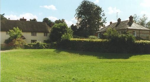 Old village pond, Vernham Dean. On the left is a thatched cottage built with chalk walls which was once a cheaper form of construction. On the right is a brick and flint cottage with a with a slate roof. Both forms of construction are typical for this part of Hampshire.