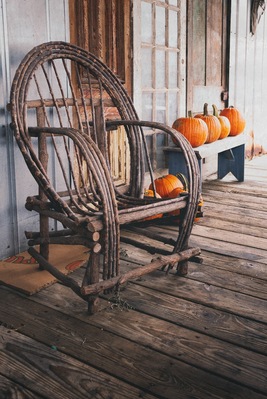 Amish rocking chair on a porch with pumpkins in Nolensville, Tennessee