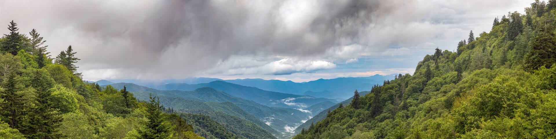 Thick morning clouds roll over the blue ridges of the Appalachian Range in Great Smoky Mountains National Park near the border of North Carolina and Tennessee. Shot from the Oconoluftee Overlook