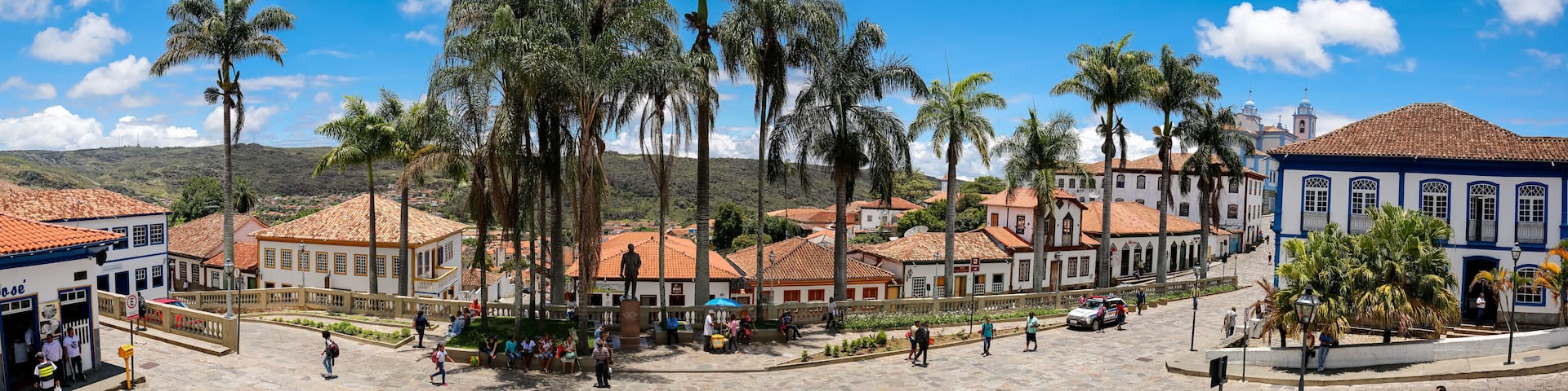 Panorama of traditional houses and palm tree lined street in historic center of Diamantina on a sunny day, Minas Gerais, Brazil