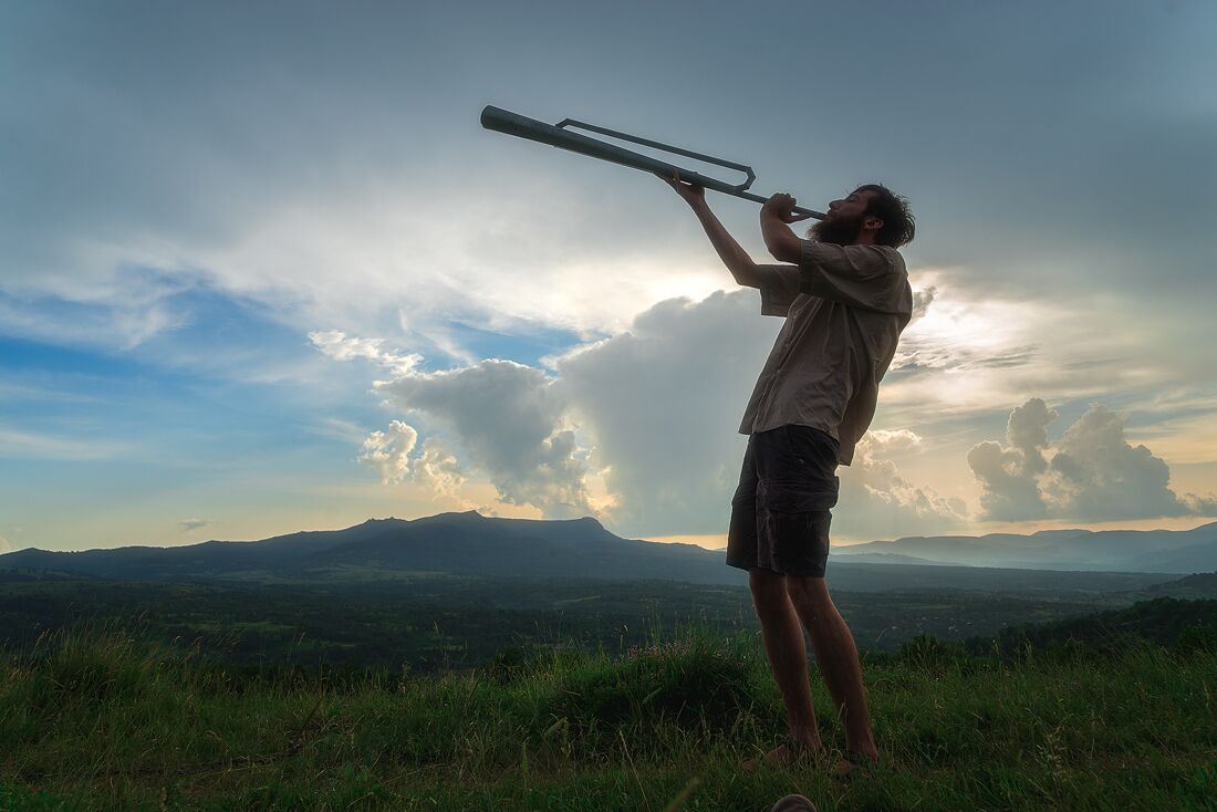 Blowing the Shepherd's horn. This horn was used to communicate over longs distances by shepherds.


I dined with shepherds for this experience: http://www.alwayswanderlust.com/dining-with-shepherds-in-the-carpathians/
