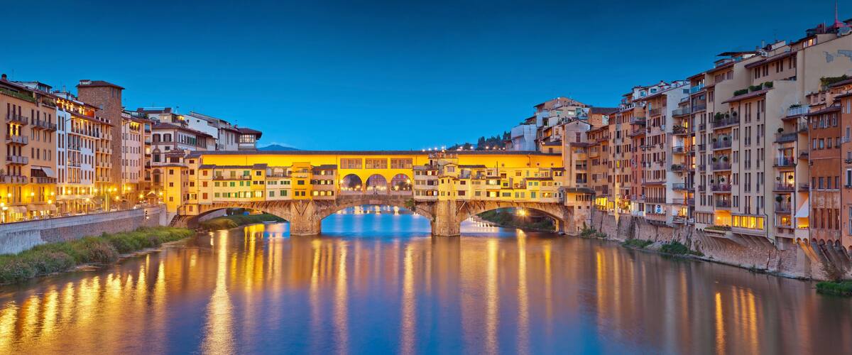 A river with a bridge and buildings on both sides.