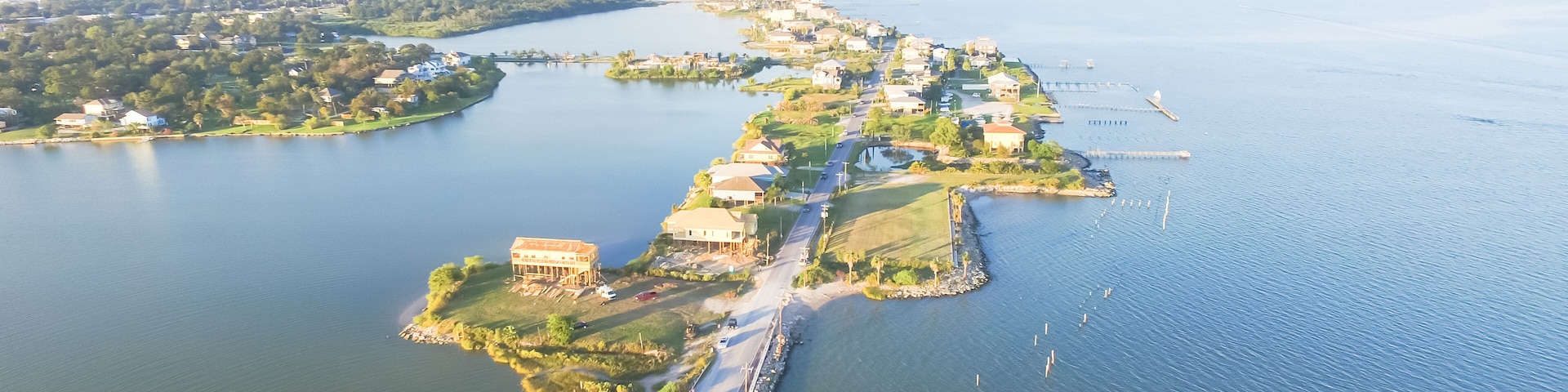 Panorama aerial view of Seabrook city near Texas Gulf Coast and Clear Lake. Waterfront harbor town with pier. Wooden vacation house under construction. Real estate and beach travel background