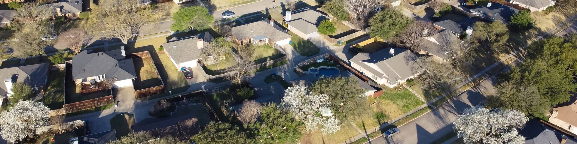 Panorama aerial view beautiful spring blossom with white Bradford pear trees surrounding residential neighborhood near Dallas, Texas, USA