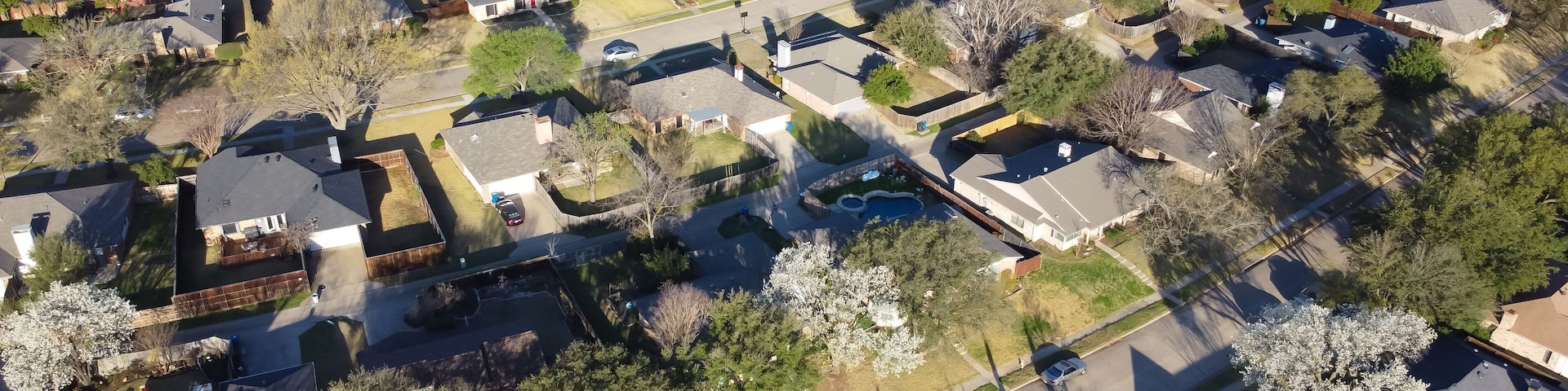 Panorama aerial view beautiful spring blossom with white Bradford pear trees surrounding residential neighborhood near Dallas, Texas, USA