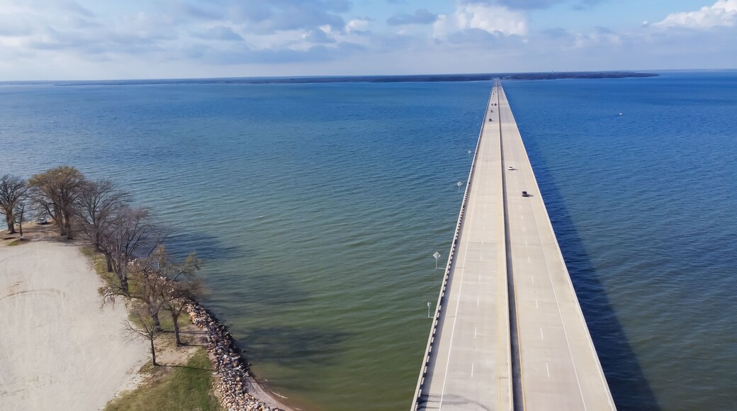 Aerial view rock wall shoreline lakefront and Two Mile Bridge over Lake Tawakoni to horizontal line in Quinlan, Texas