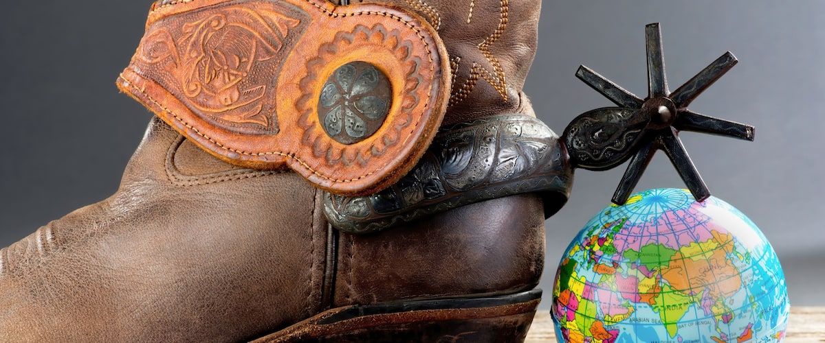 A cowboy boot, a compass, and a globe.