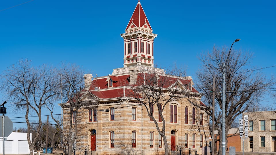 A historic church with a red steeple and stone architecture.