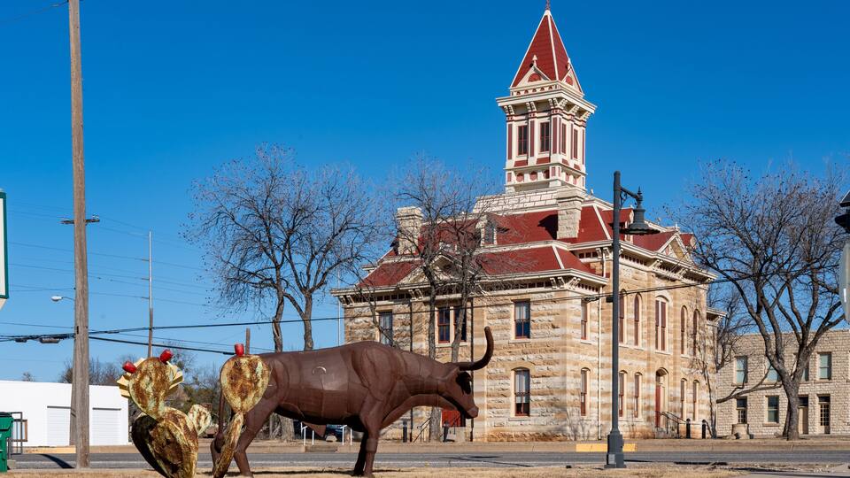 A historic building with a red roof and a clock tower.