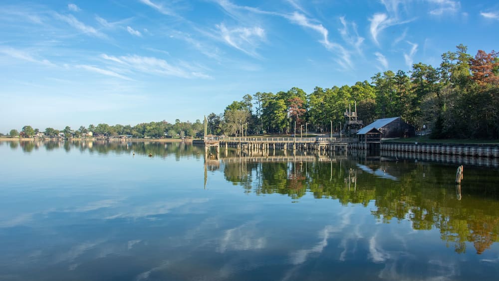Serene view of Lake Livingston reservoir with nice coulds reflecting in still waters in the East Texas Piney Woods in Polk County, Texas, United States