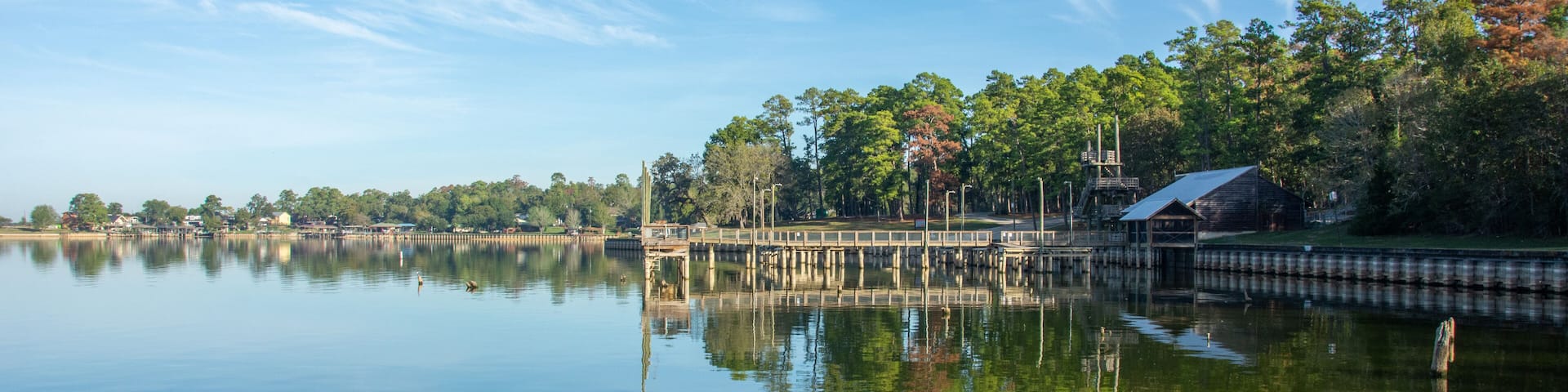 Serene view of Lake Livingston reservoir with nice coulds reflecting in still waters in the East Texas Piney Woods in Polk County, Texas, United States