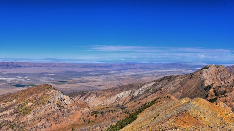 A mountainous landscape with rugged peaks and a vast valley.