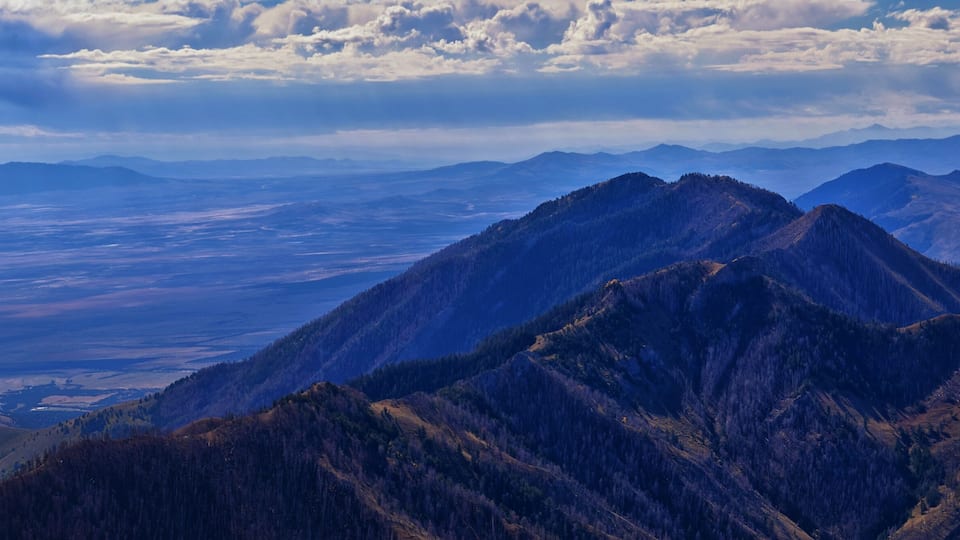 A mountain range with a valley in the background.