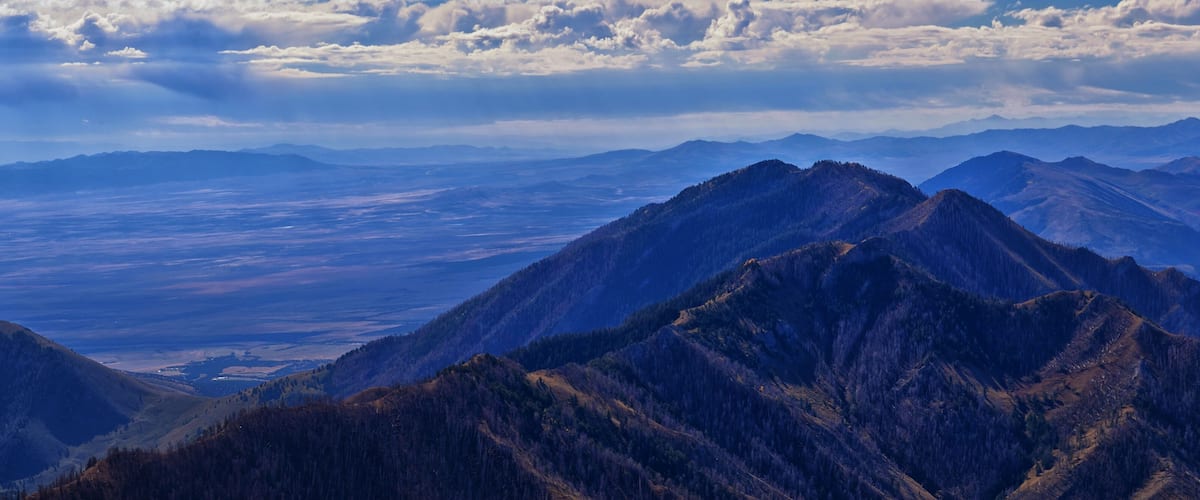 A mountain range with a valley in the background.